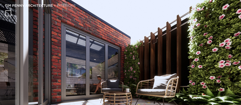 external paved patio with casual outdoor seats and ottoman in front of a small garden area
