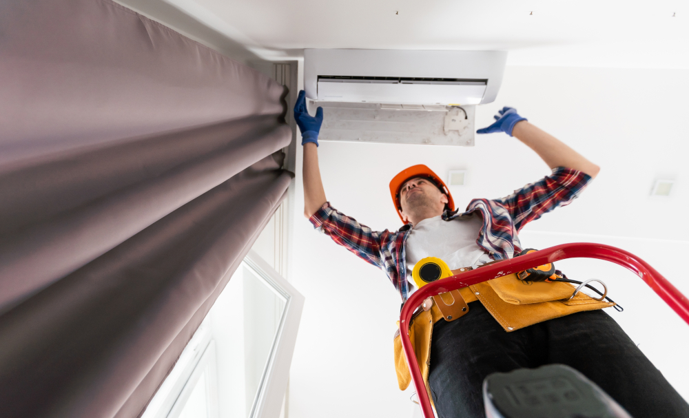 Contractor performing maintenance on an air conditioner